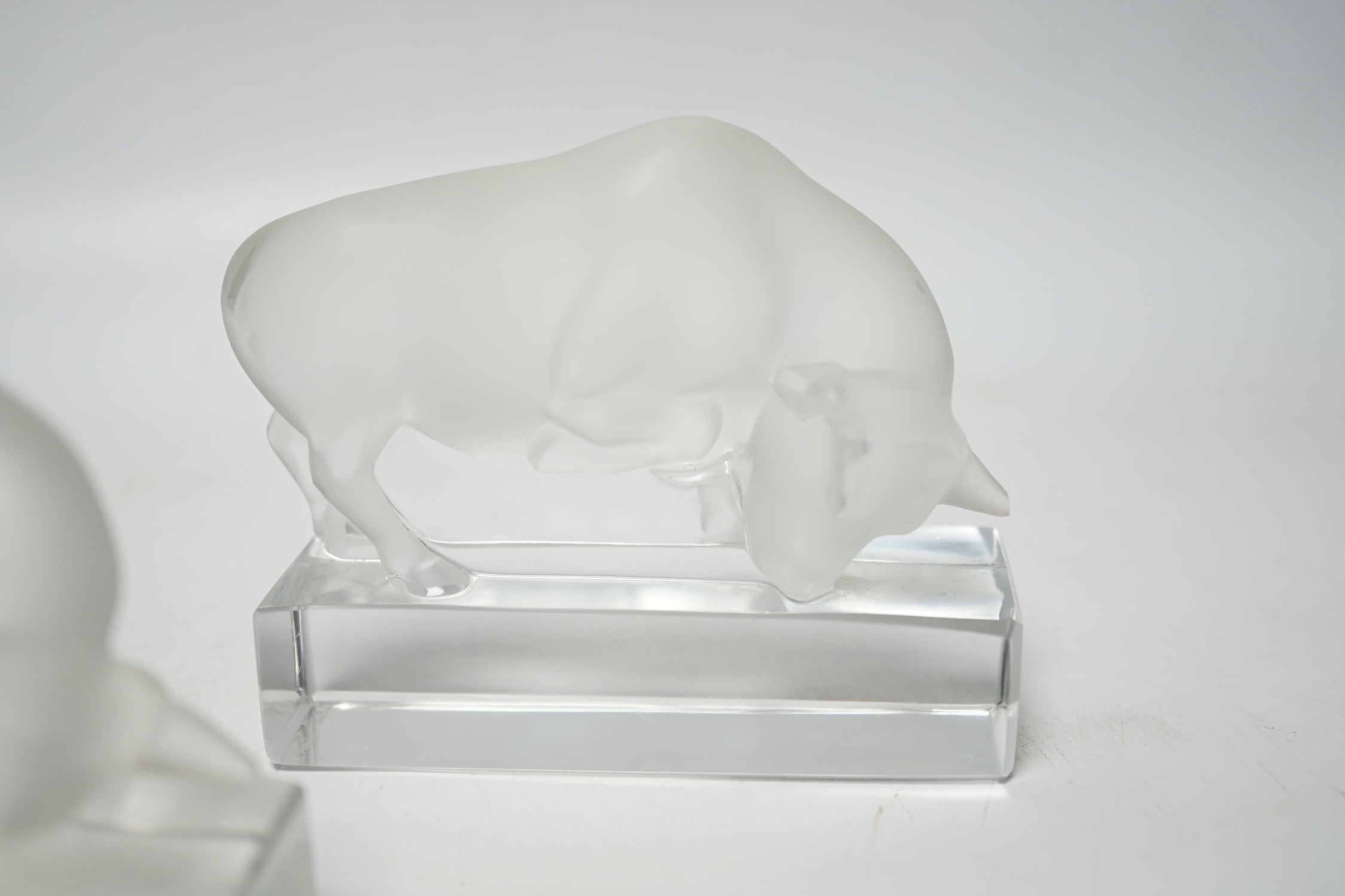 Rene Lalique, two frosted glass paperweights modelled as a bull, signed ‘Lalique France’ to base, 9cm high